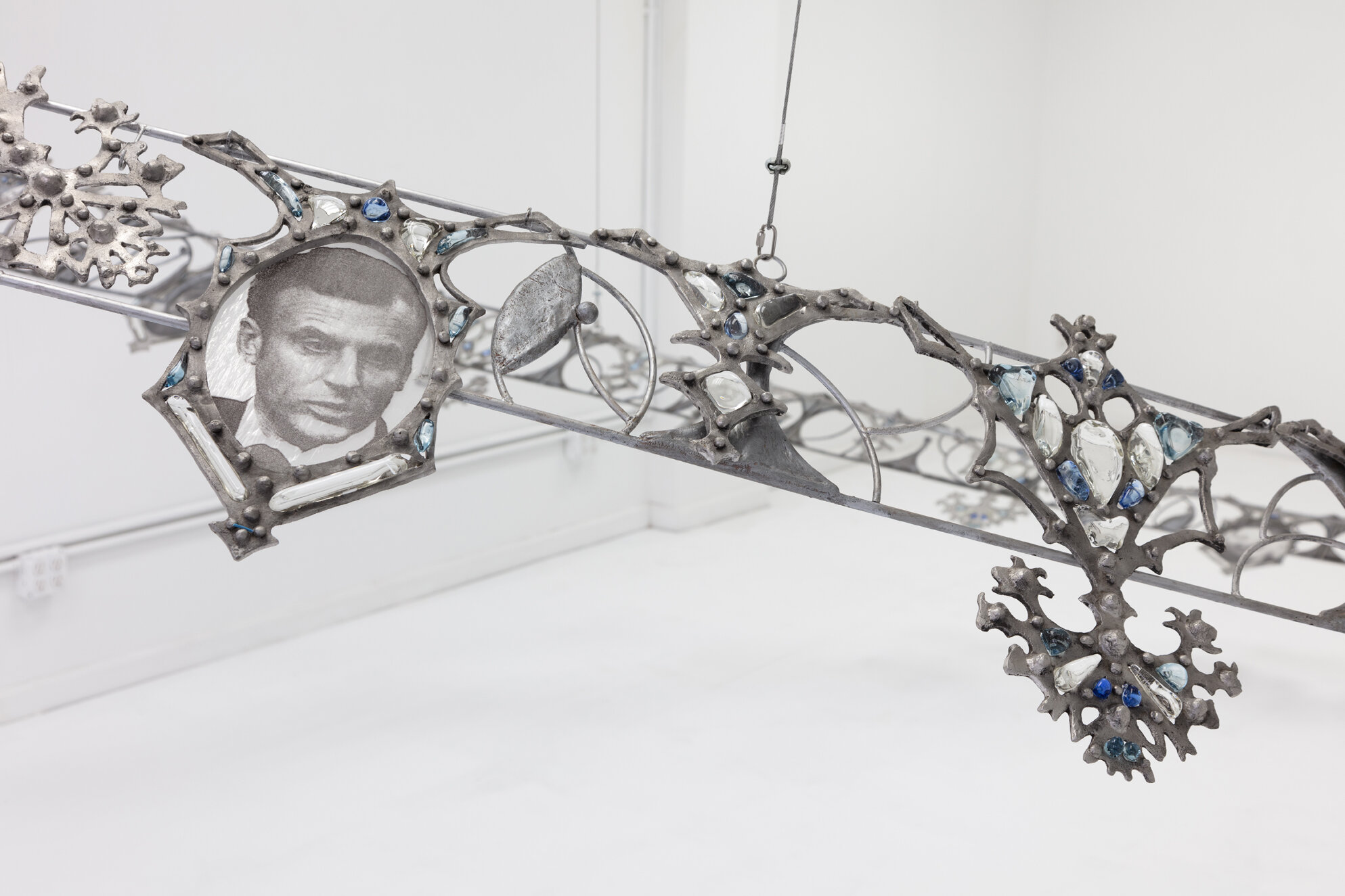   Fallout Necklace  (detail), 2018. From the series  Trophies of Abuse.  Patined cast aluminum, patined steel, flame-worked glass, powder printed glass. 84 x 120 x 180 inches.  