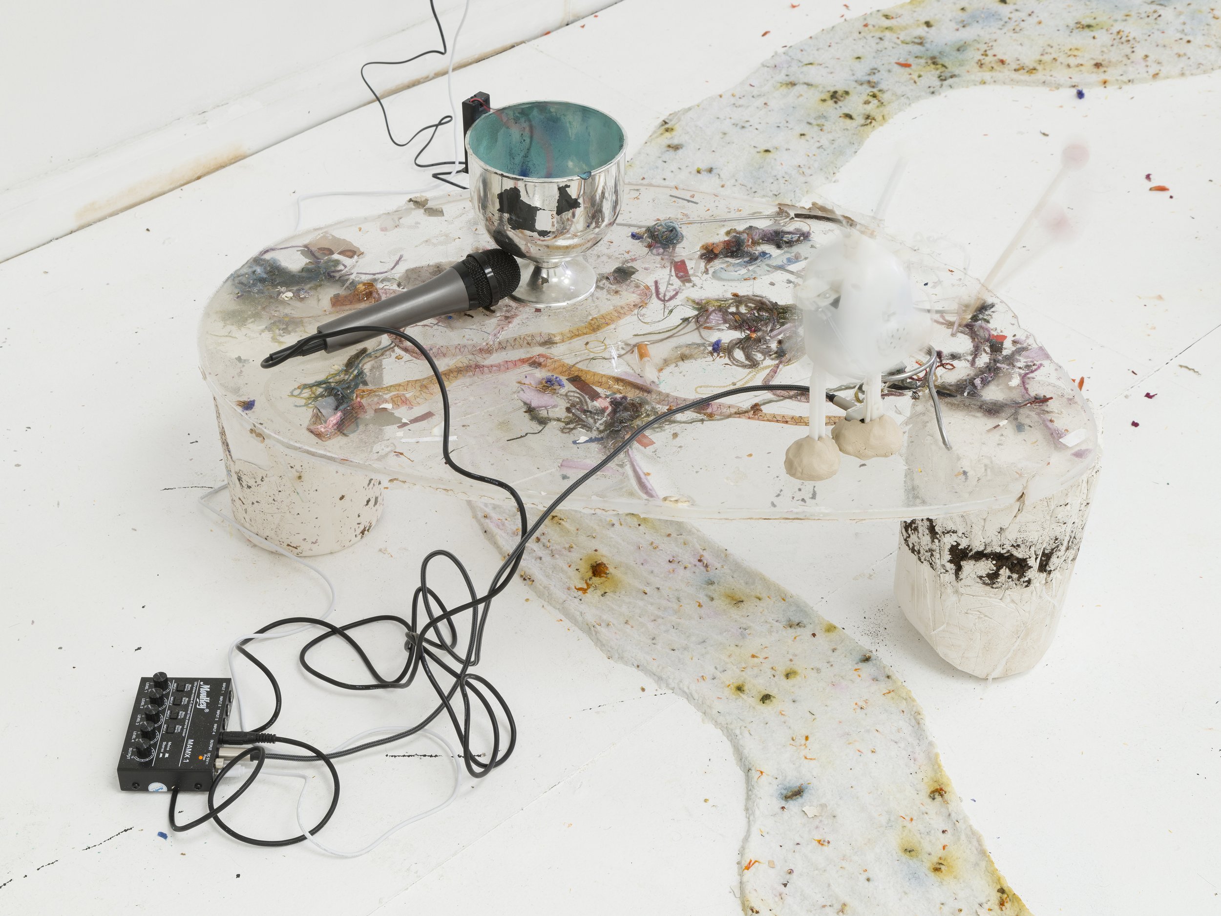   Duet Dance,  2022. Plaster, compost soil, amplifier, microphone, dancing toy, bell, vibrating motor, mica powder, resin, air dry clay, studio debris. 19.5 x 29 x 18.8 inches. 