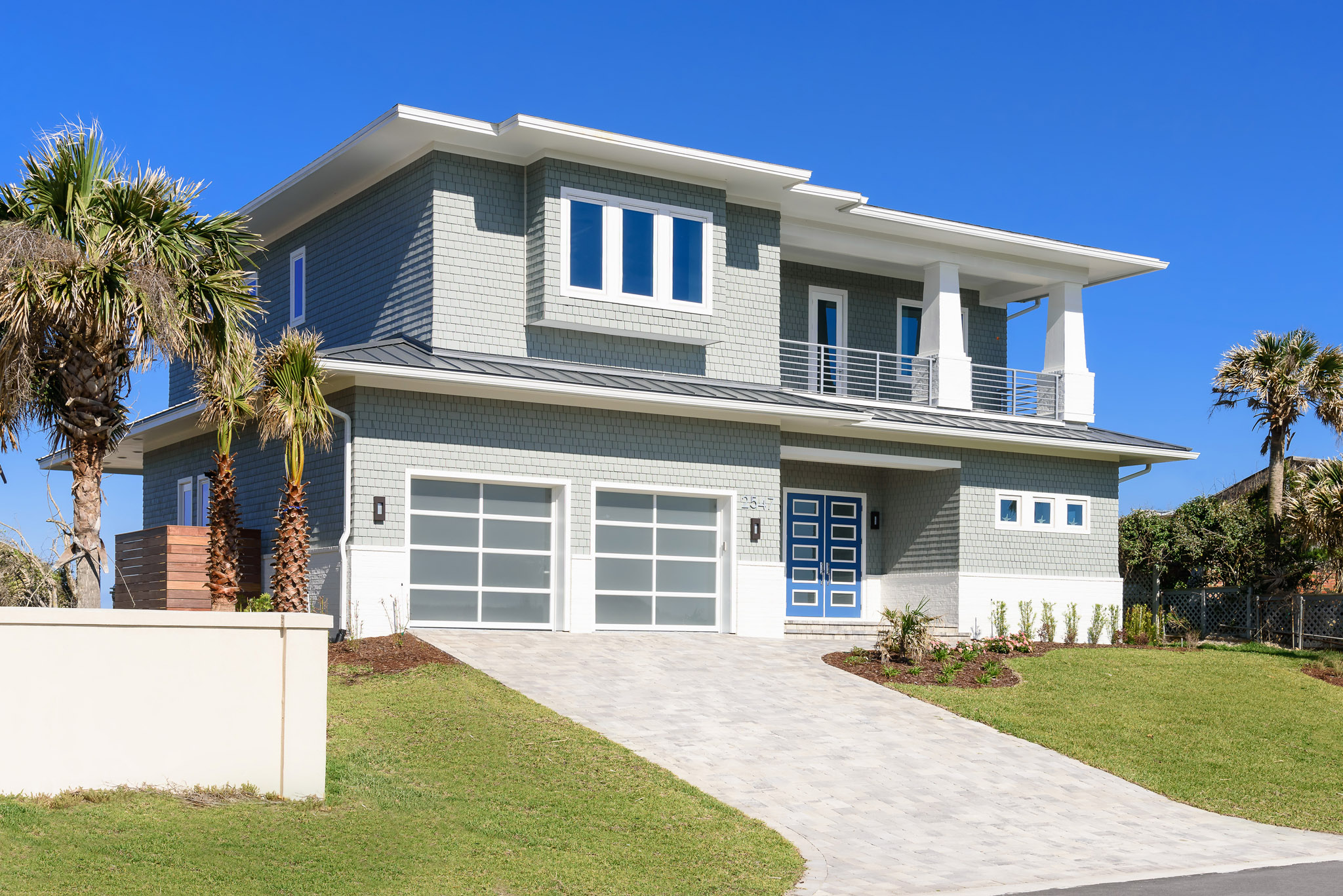High enough on the dunes to afford views of both the Atlantic Ocean and the Intracoastal Waterway, this home presents a striking image from the front.