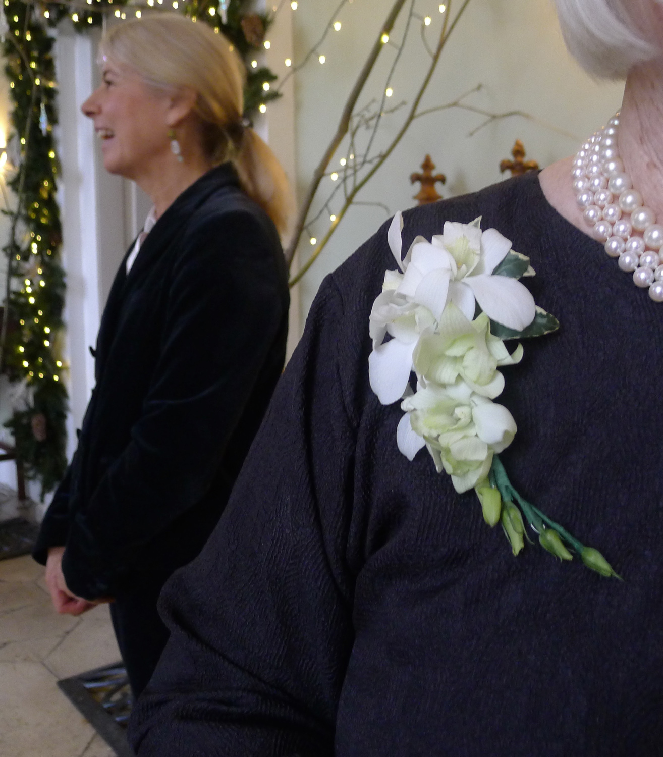 corsage of dendrobium orchids and ivy leaves