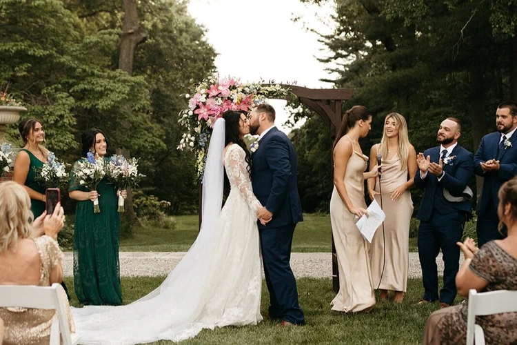 Dark wood arbor at an outdoor ceremony