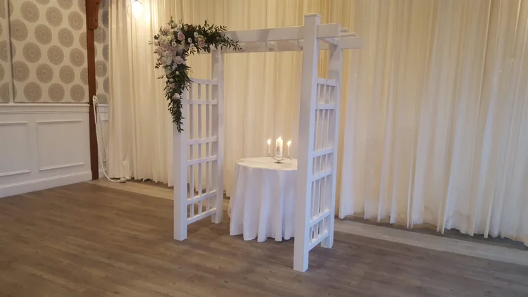 Traditional white wedding arch