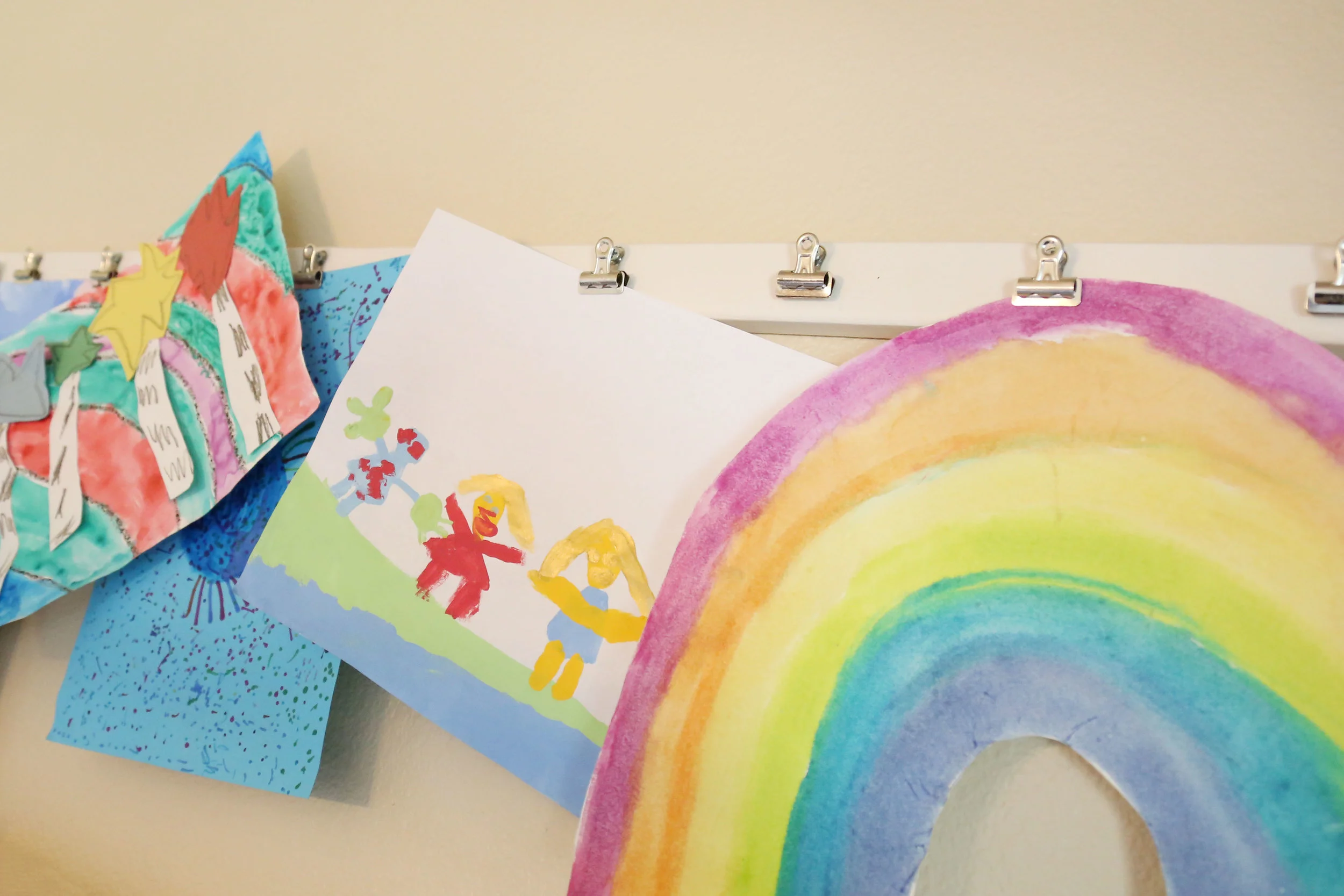 ART DISPLAY : We used a thin piece of wood and some clamps to create an over-sized art display to show off their masterpieces.