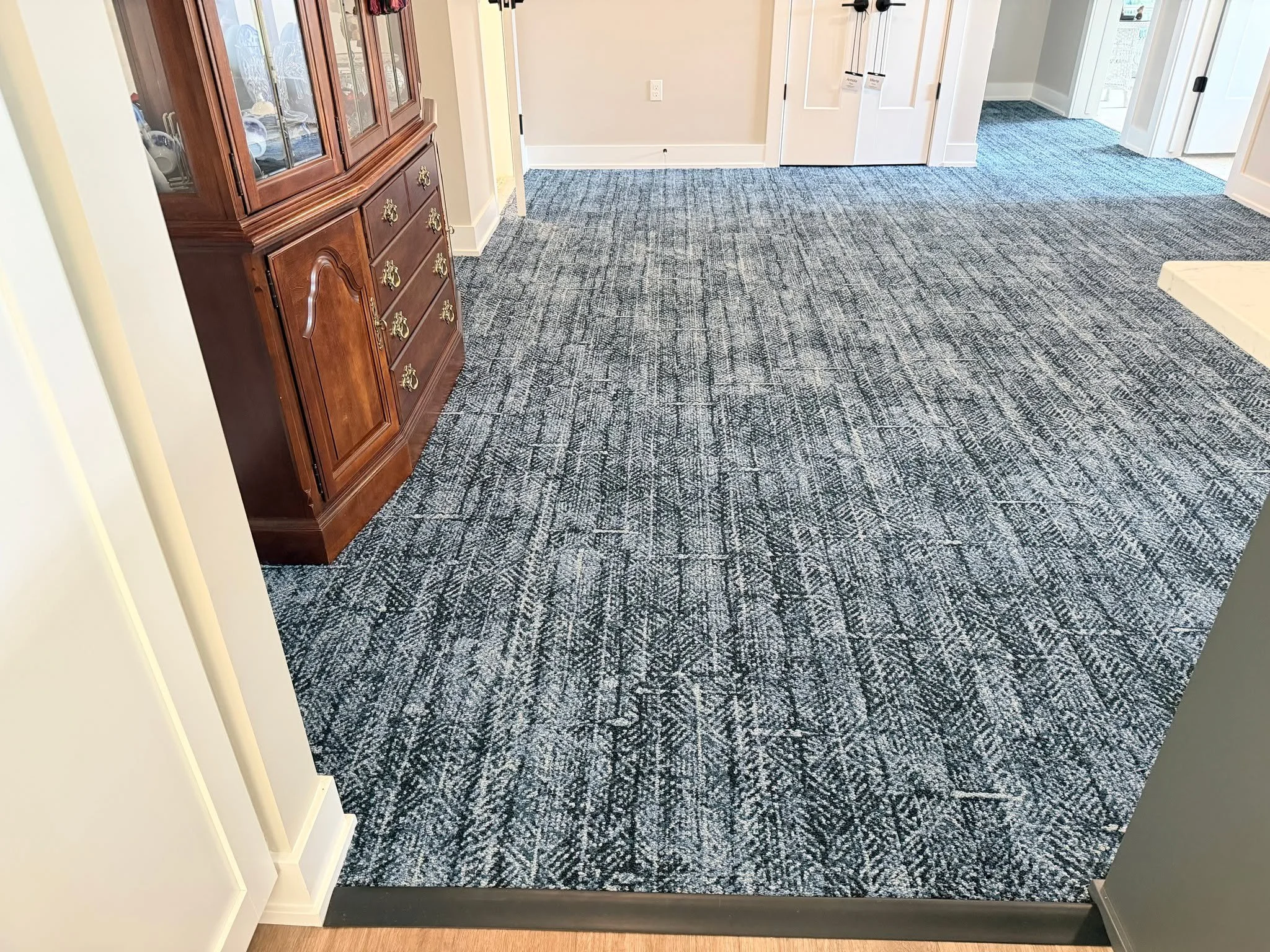For this installation, carpet plank was installed over the existing LVT using a floating application system, providing an updated look while preserving the existing substrate.

The best part? Hearing from the homeowner afterward:
"We couldn't be