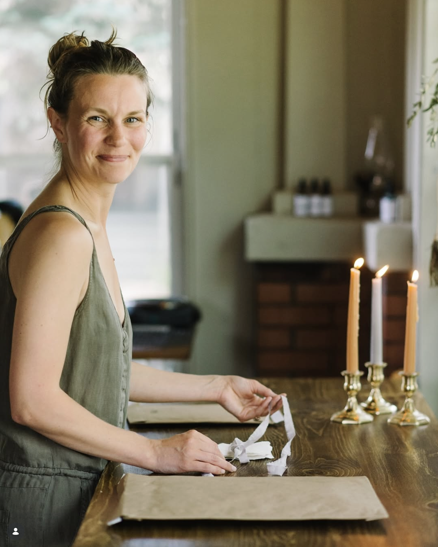 A wedding album designer in studio tying ribbon
