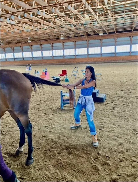 Cristy Hunter with a horse at the barn