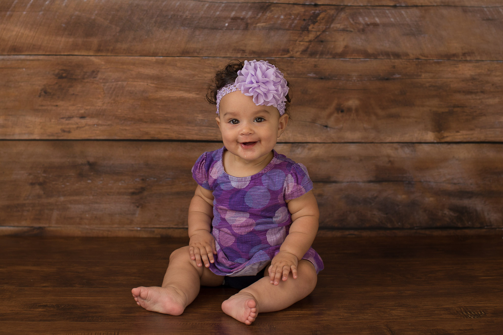 baby-girl-wood-backdrop-purple-outfit.jpg