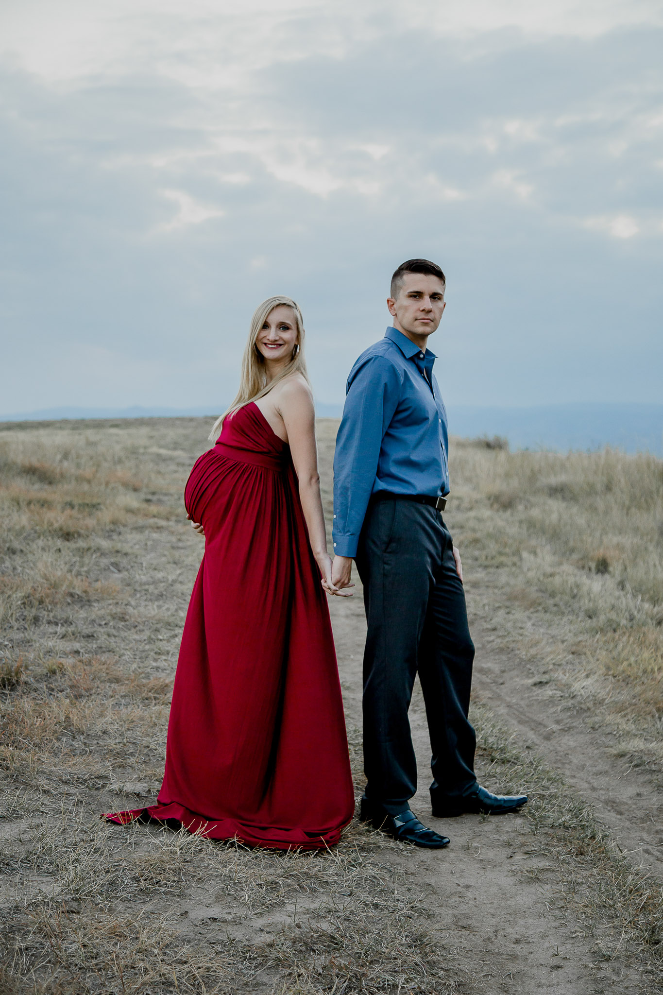 Maternity-Couple-Holding-Hands-Sunset-Red-Gown.jpg