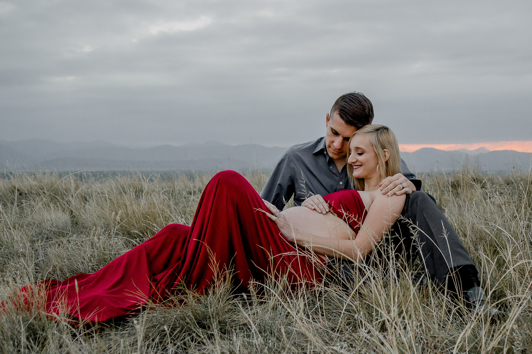 Romantic-Maternity-Couple-Field-Laying-Down-Red-Dress-Littleton.jpg