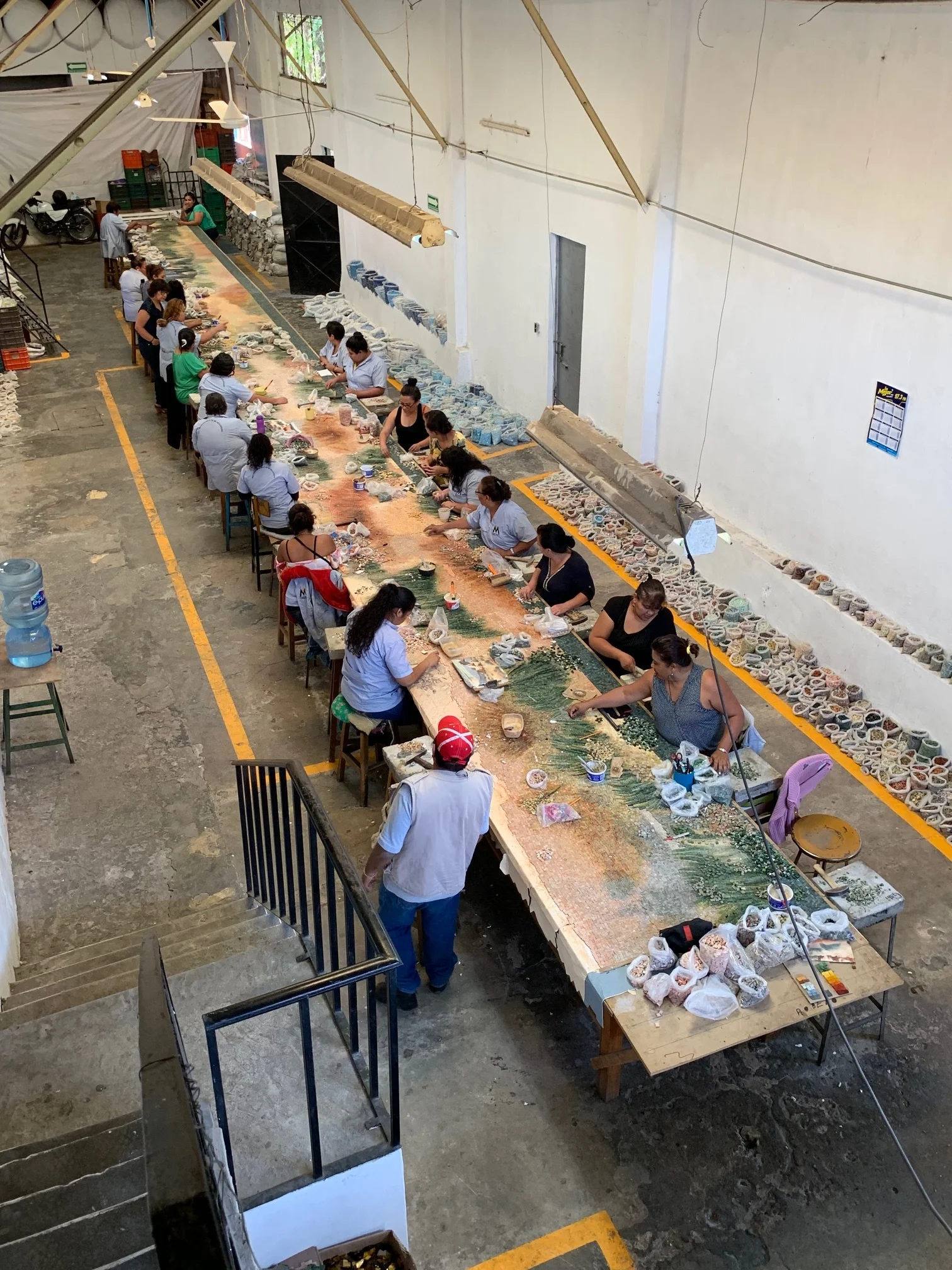 The talented artisans behind the creation of this mosaic tile mural.