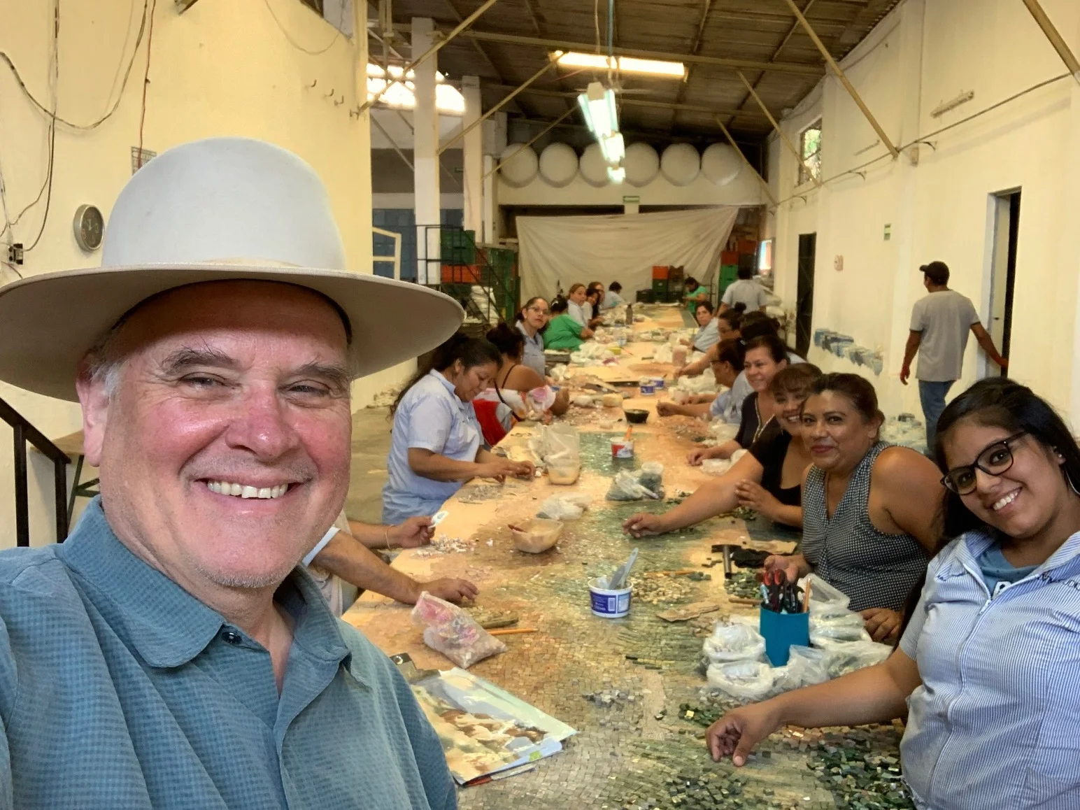 William Matthews with the talented team of artisans working on his mosaic tile mural.