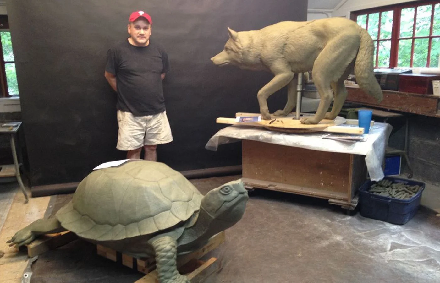 COURTESY OF DONALD LIPSKI Philadelphia-area artist Chris Collins stands with models of two of the seven new animal sculptures in Fishtown.