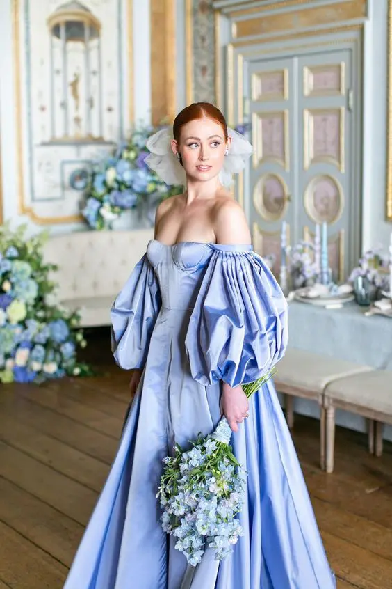 10-a-jaw-dropping-Bridgerton-inspired-bridal-look-with-a-gorgeous-royal-blue-off-the-shoulder-wedding-dress-with-a-corset-and-puff-sleeves.png