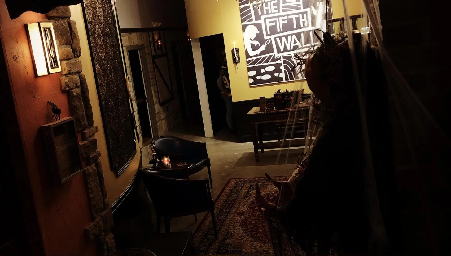 Interior lobby of The Fifth Wall Escape Rooms with themed decor and mural
