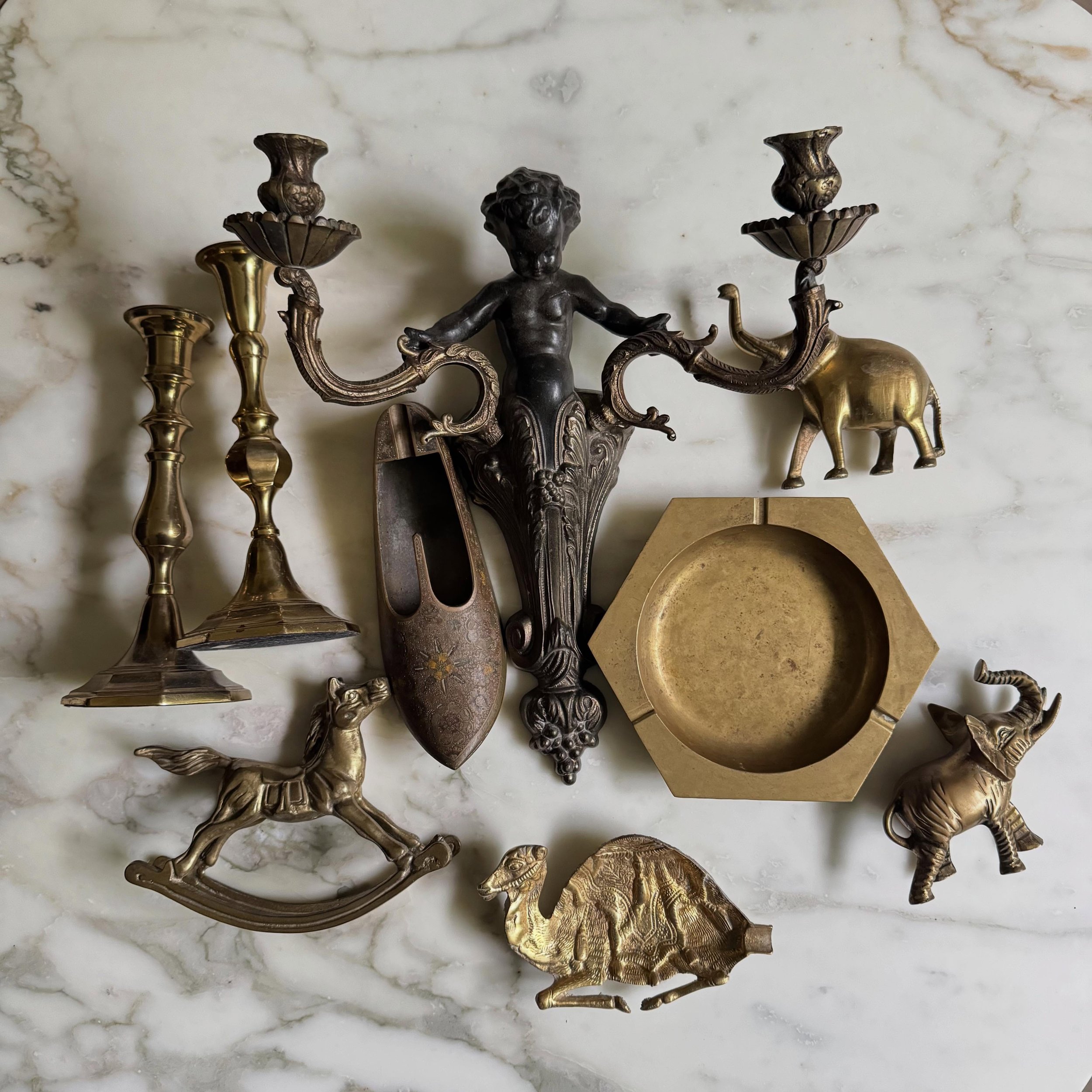 Lots of brass in the shop! Comment Claim to Purchase! #flatlayfridaysale 

1. MCM hexagonal ashtray $75 + ship

2. Brass Rocking Horse $52 + ship

3. MCM Camel Ashtray $52 + ship

4. Similar but Different candle stick duo $42 + ship

5. MCM Large Ala
