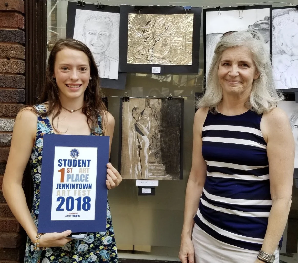 Elizabeth is pictured above alongside Mrs. Elena Cipolla, teacher of studio art at Martin Saints. Below, left: Martin Saints student submissions at the Festival; below, right: Elizabeth’s winning drawing.