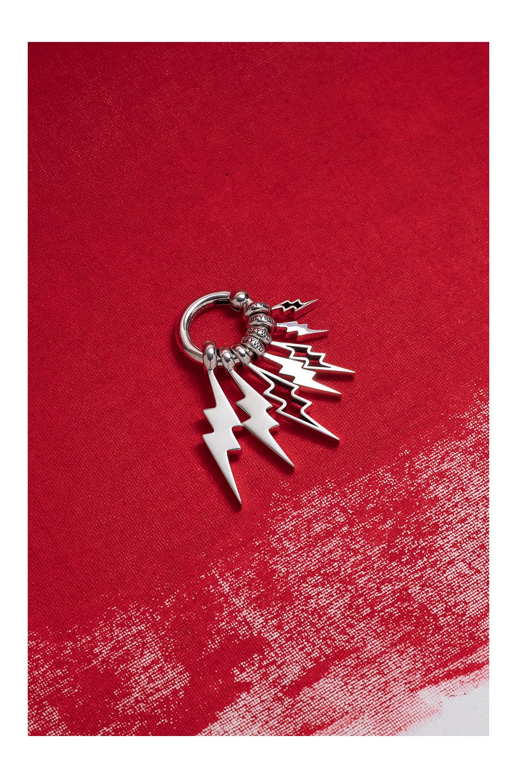 Good Art HLYWD sterling silver lightning bolt charms — commercial jewelry photography by Daniel Ponce, San Francisco