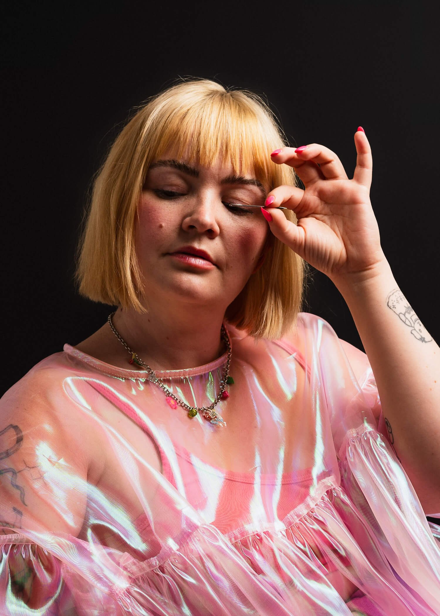 Alex Lunt, tailor and founder of NettlesStudios, in an iridescent pink garment with eyes closed — portrait photography by Daniel Ponce, San Francisco