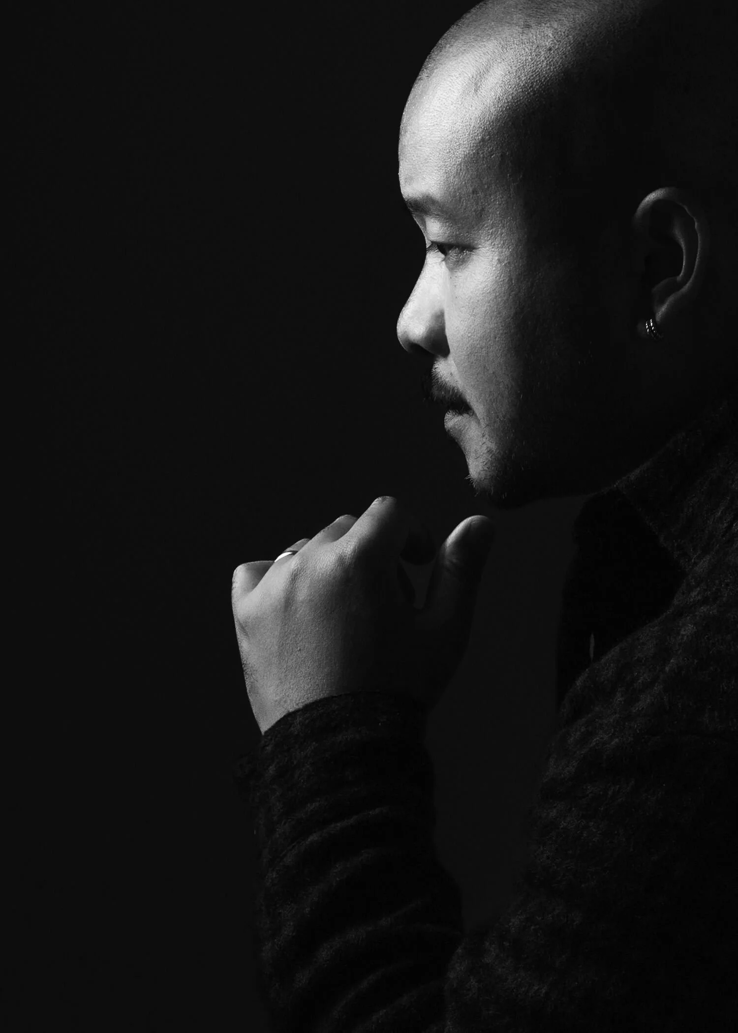Black and white studio portrait of Anthony, profile with dramatic side lighting — personal branding photography by Daniel Ponce, San Francisco