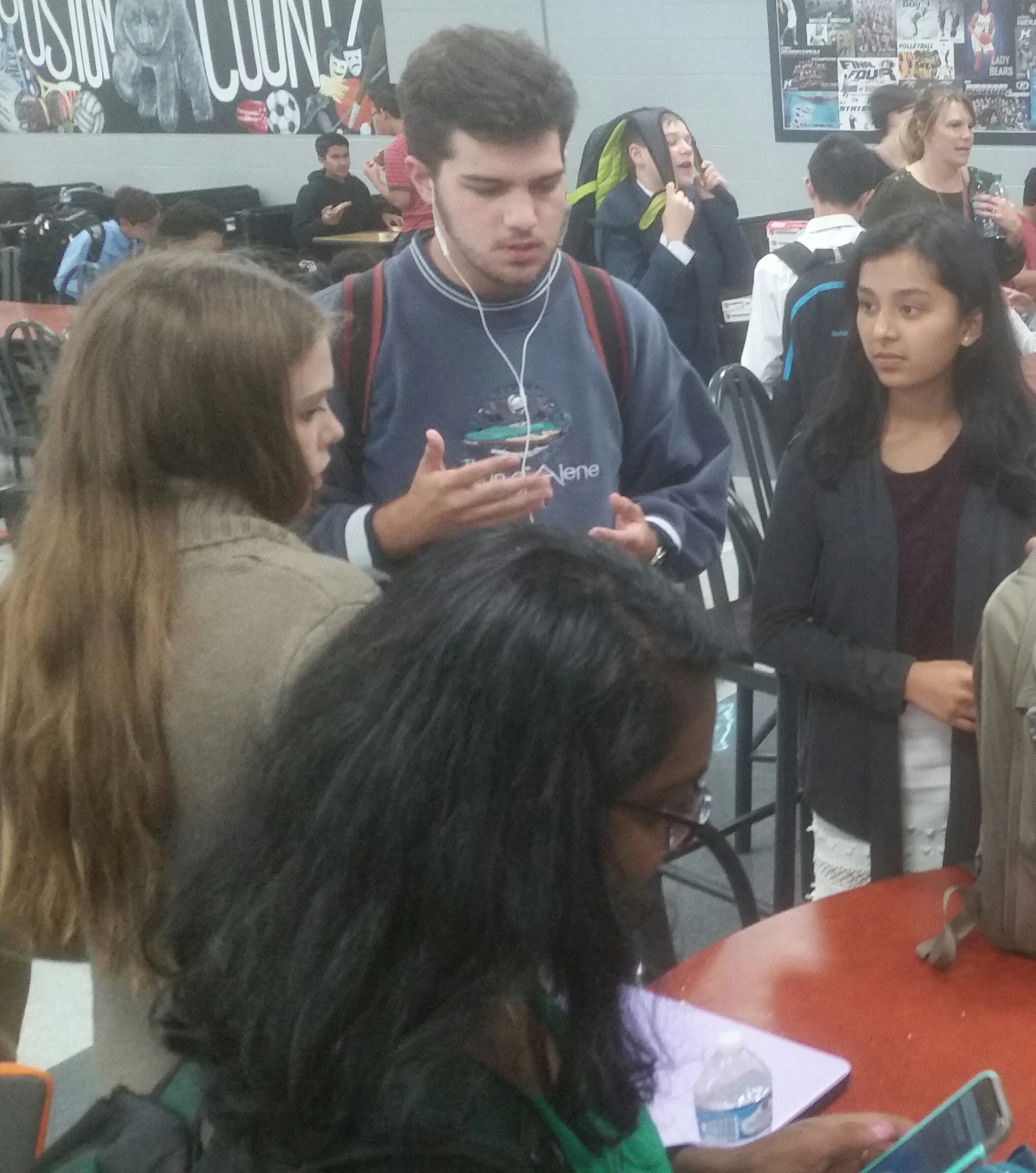 Sam Georgecink coaches Sophie Murtey and Priyanka Parikh before their quarterfinal round at Houston County.