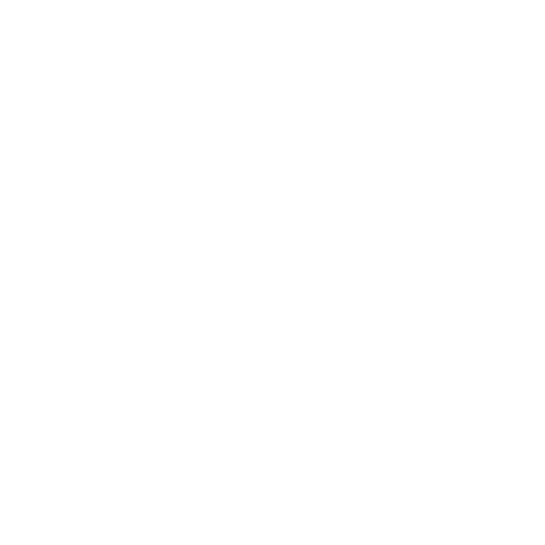 A modern house with stone and wood exterior situated on a grassy hillside with snow-capped mountains in the background.