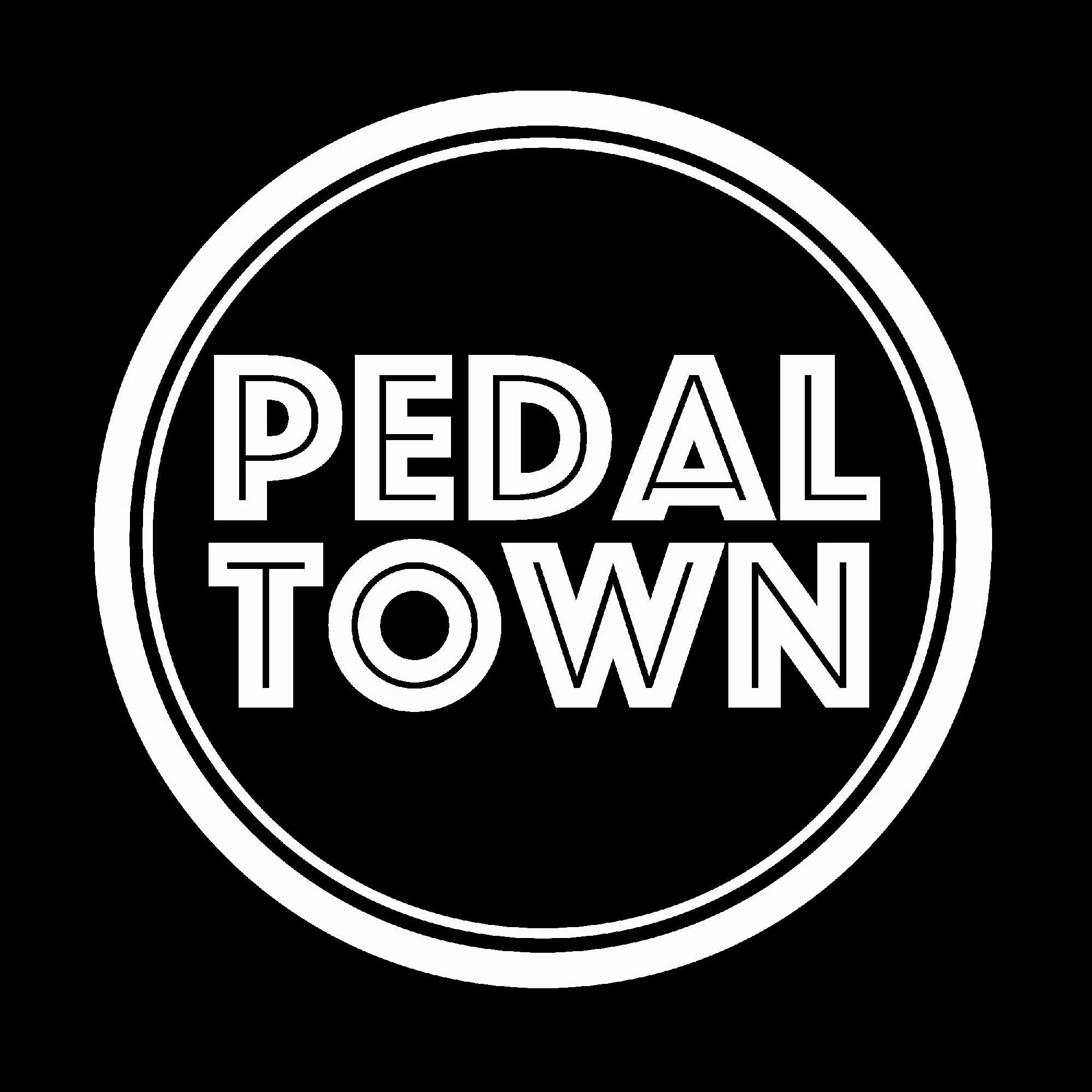 Black circular logo with the words 'Pedal Tow' inside, outlined with two white rings.