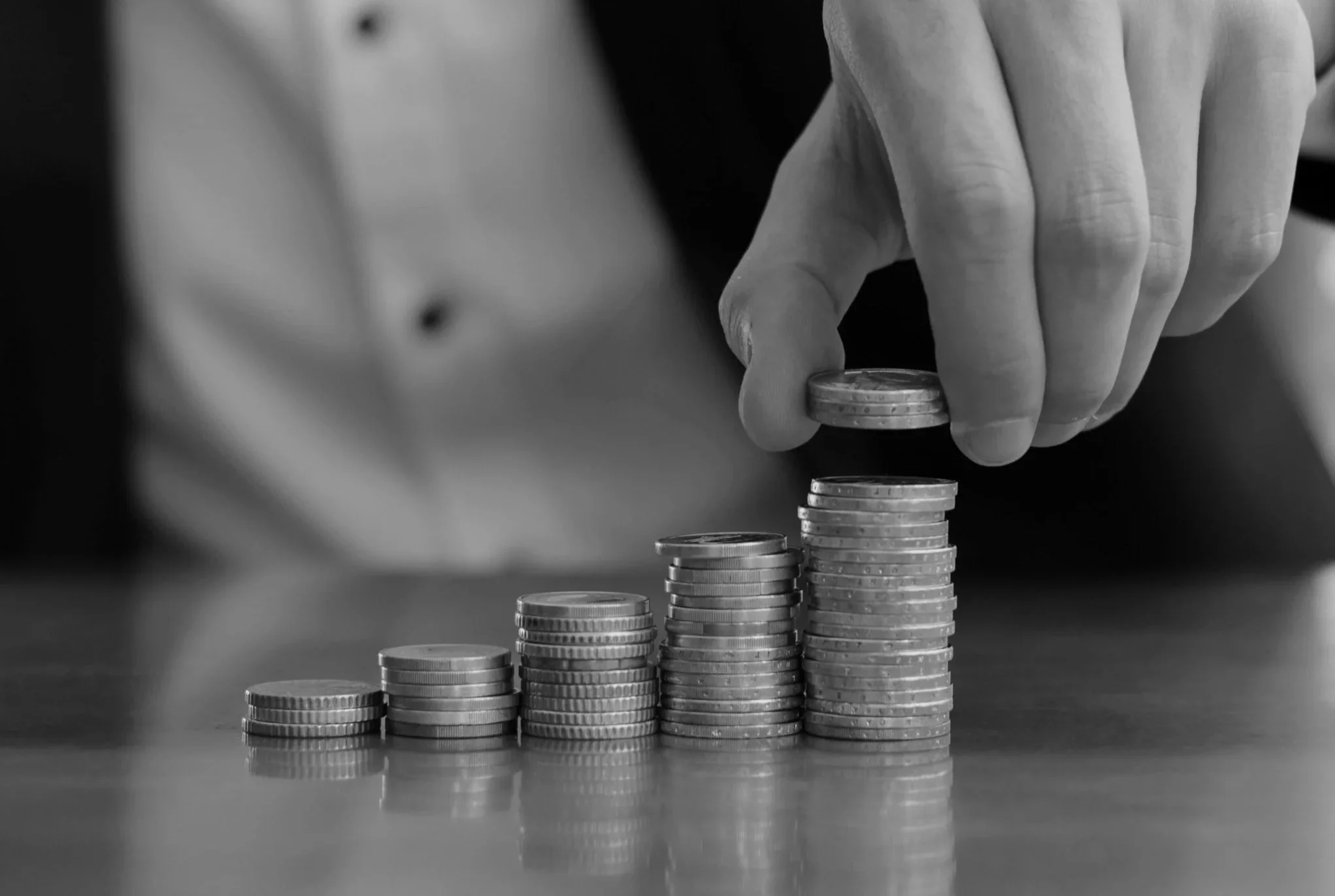 closeup-shot-businessman-s-hands-counting-stacks-coins-after-business-success.jpg