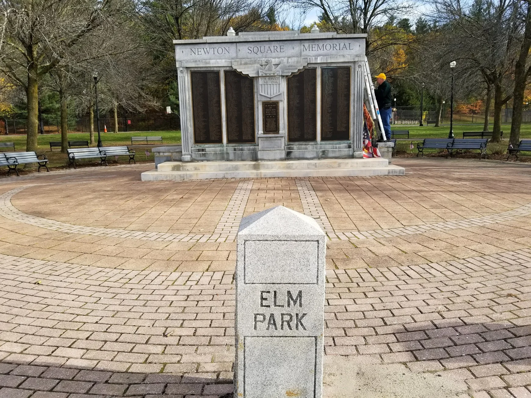 Rick hangs flags on the Newton Square Memorial for Veterans Day 2017