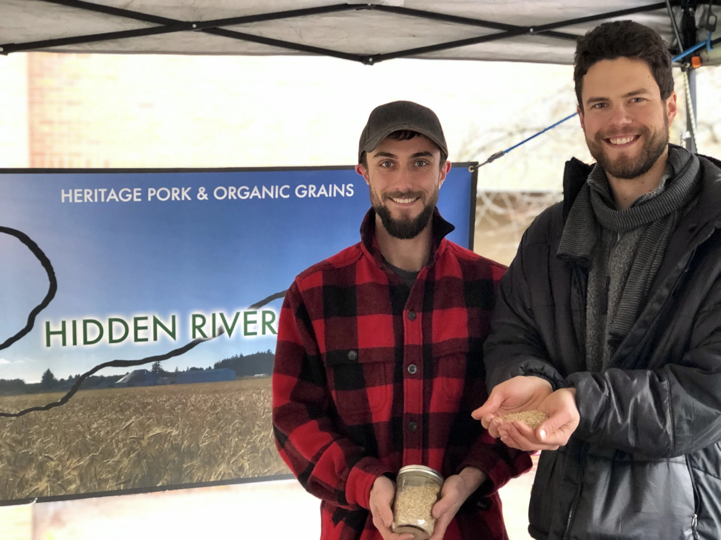 Farmers Evan and Mericos holding some gorgeous local grain, before our chickens eat it.
