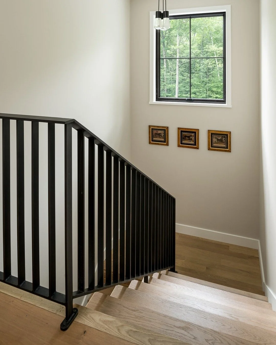 This simple but elegant railing is hand crafted out of solid steel flat bar, expertly welded together and then sand blasted for a uniform feel. 
The final finish is acrylic clear coat over acid blackened raw steel for a subtle but lovely black colori