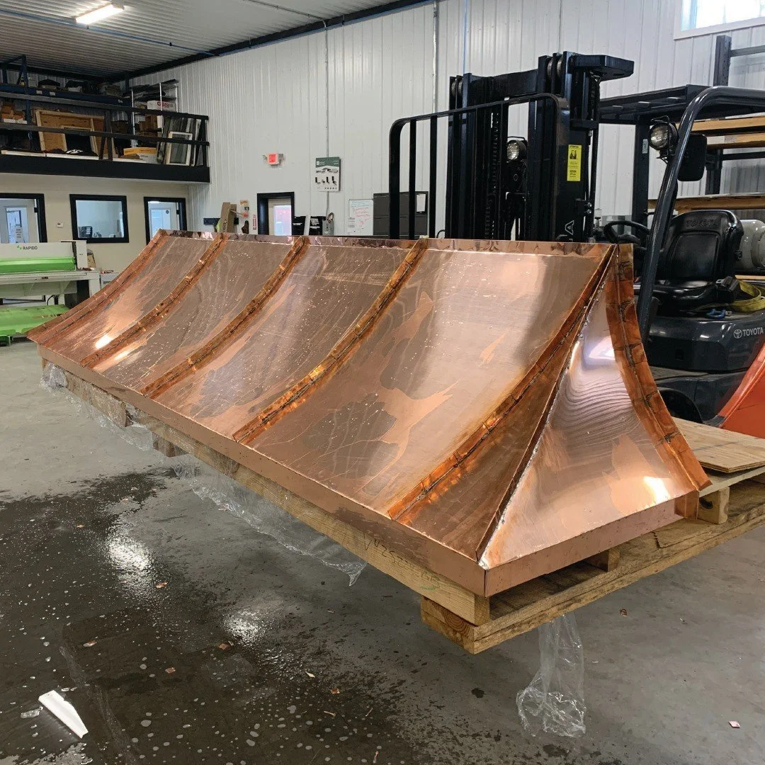 Compound curves coming together nicely on this copper awning roof for a local contractor. Fully hand made, custom copper pans laid over a wooden substructure provided by the client. Soldered seams for a watertight seal, washed and ready to install!