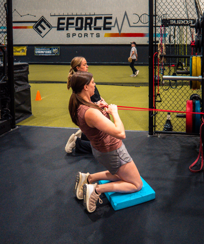 Physical therapist assisting a patient with a sports rehabilitation assessment