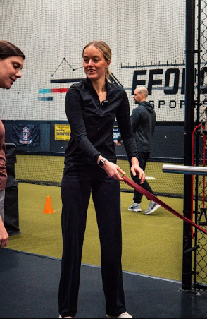 physical therapist performing one-on-one manual therapy with an athlete
