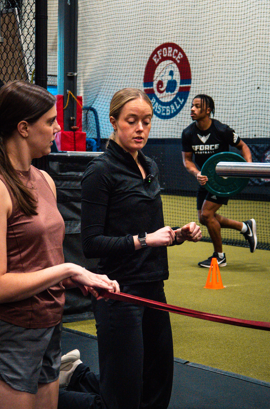 physical therapist performing one-on-one manual therapy with an athlete