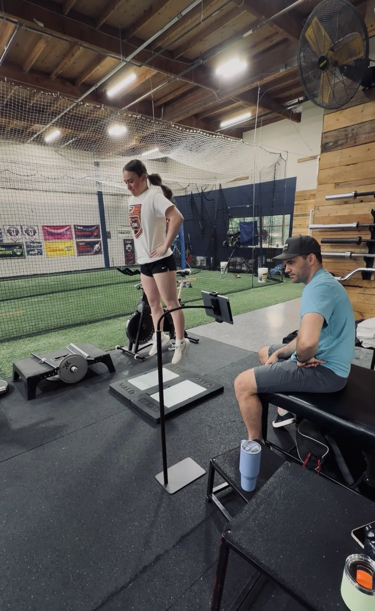 Individual jumping on a force plate with a physical therapist