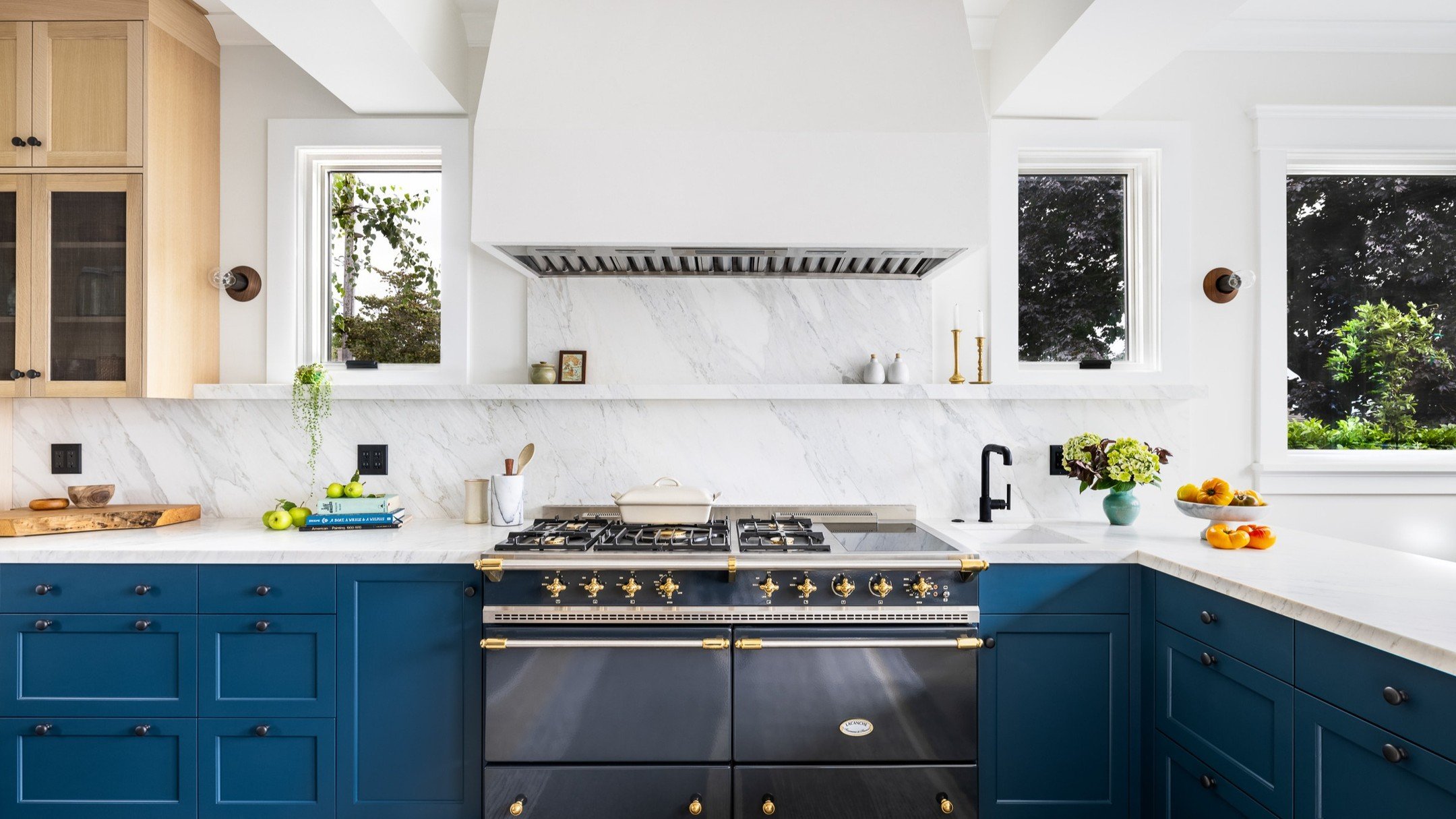 This prussian blue kitchen still gives us serious kitchen envy. From the rift white oak uppers, to the French range, and the tadelakt plaster hood -- we could see ourselves joyfully simmering, stewing, and stirring in this room for years to come.

#c