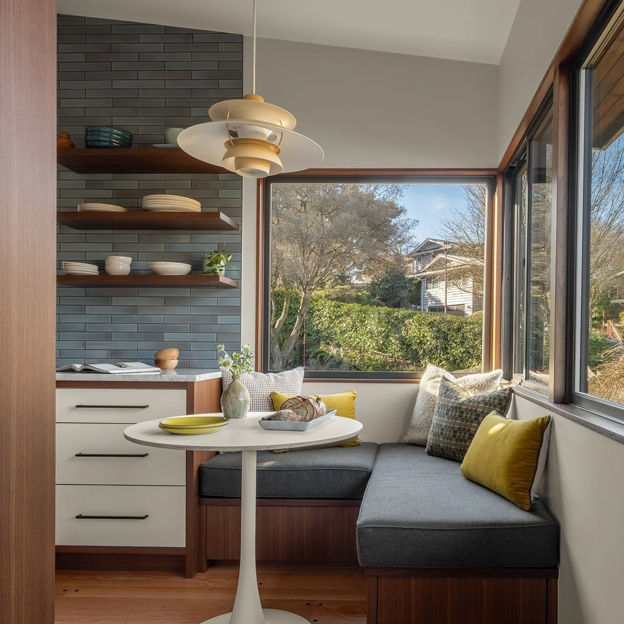 We were more than ready to ditch the cramped 1956 layout, but we knew the breakfast corner had to stay.

While we said "see ya later" to restricted layout, we decided to lean into the original breakfast nook by building in this petite banqu