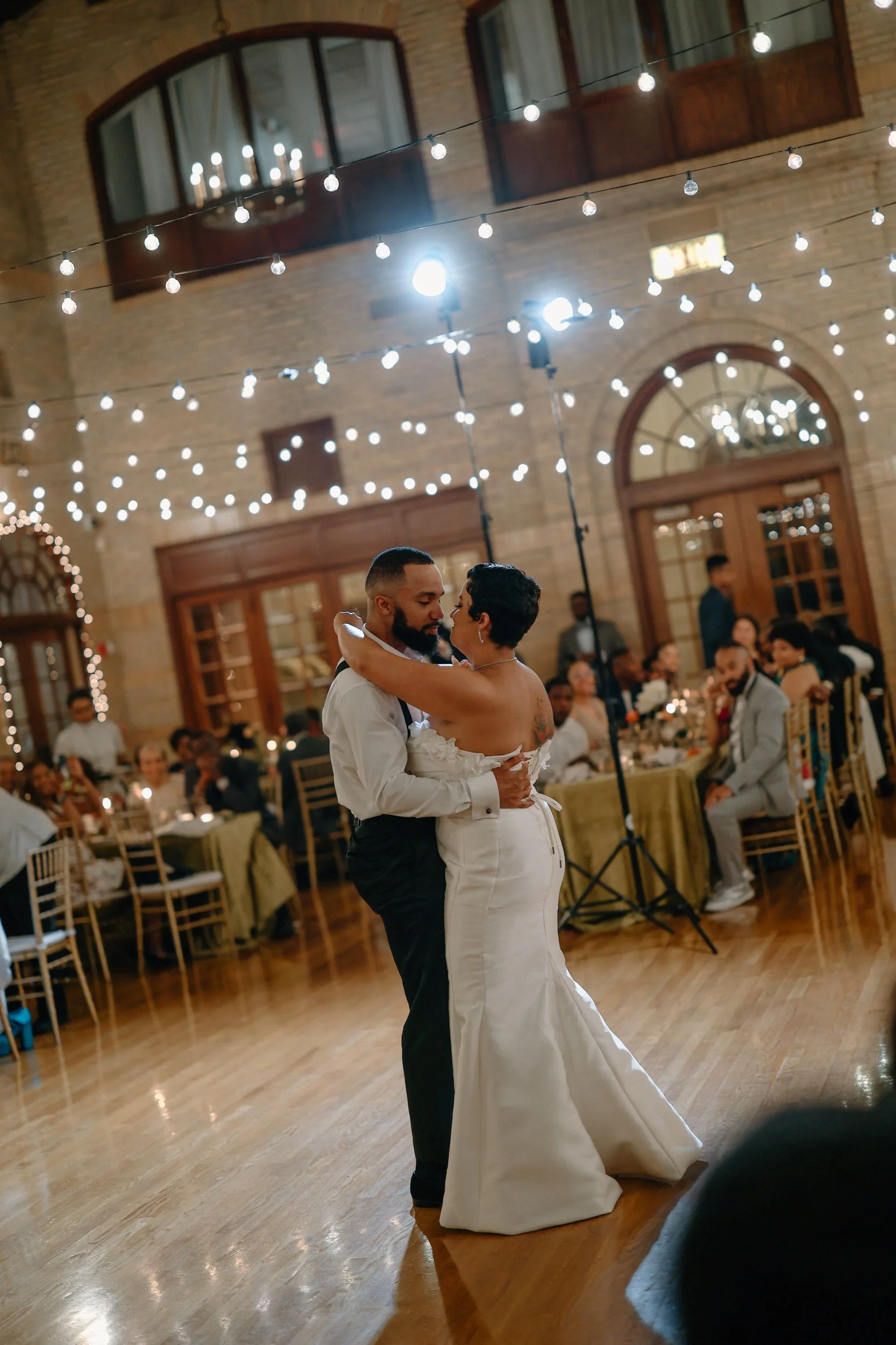 Real couple dancing at wedding reception in Washington, D.C. while guests are onlooking