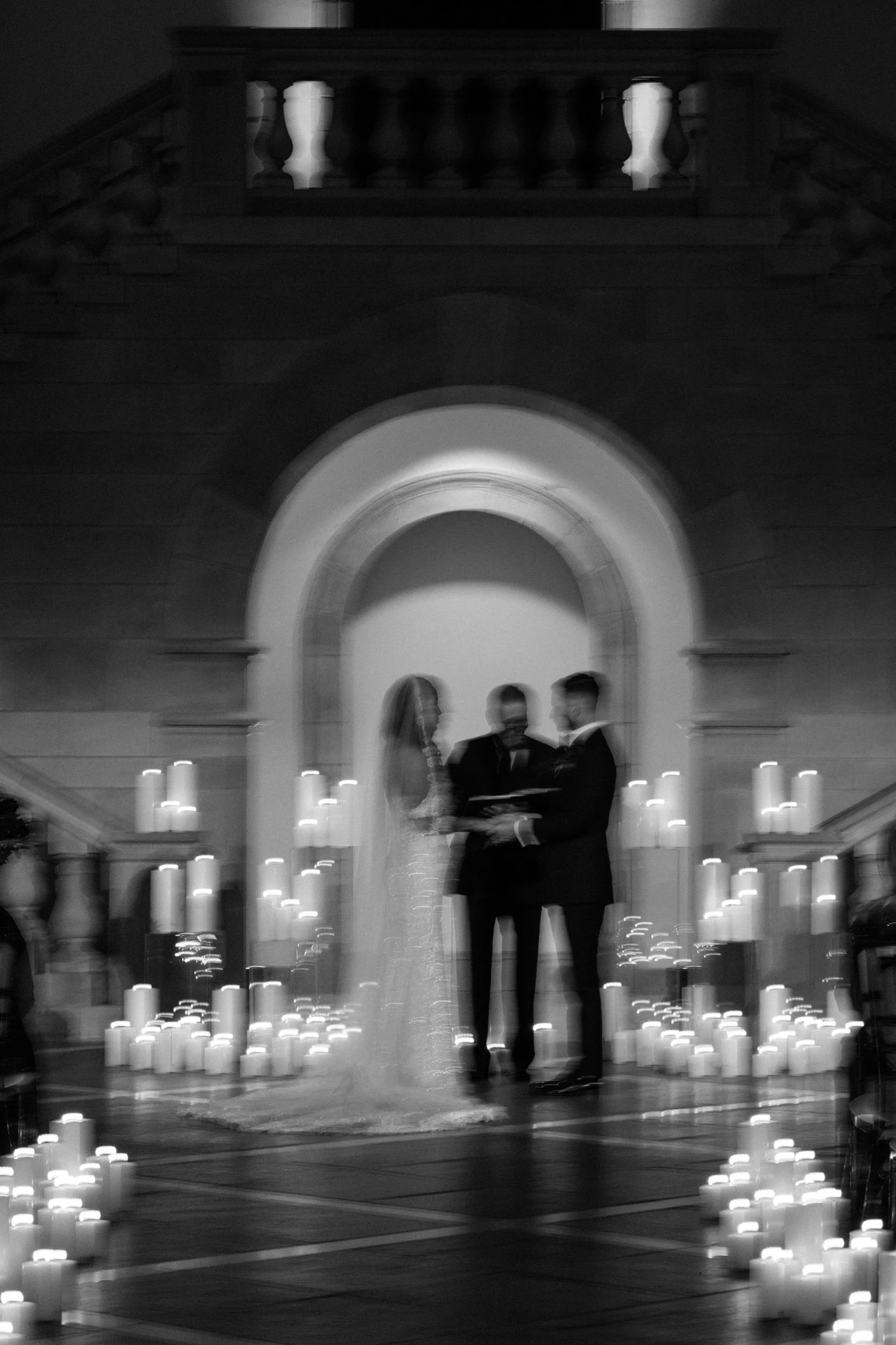 Elevated wedding ceremony designed by By Love Events & Design in Norfolk, Virginia featuring dramatic candle display at chrysler museum of art