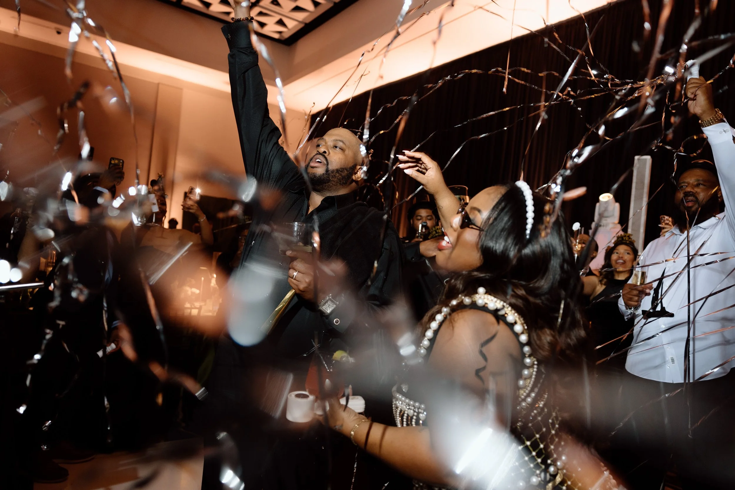 Bride and groom celebrating with champagne and confetti at elegant wedding reception in Virginia