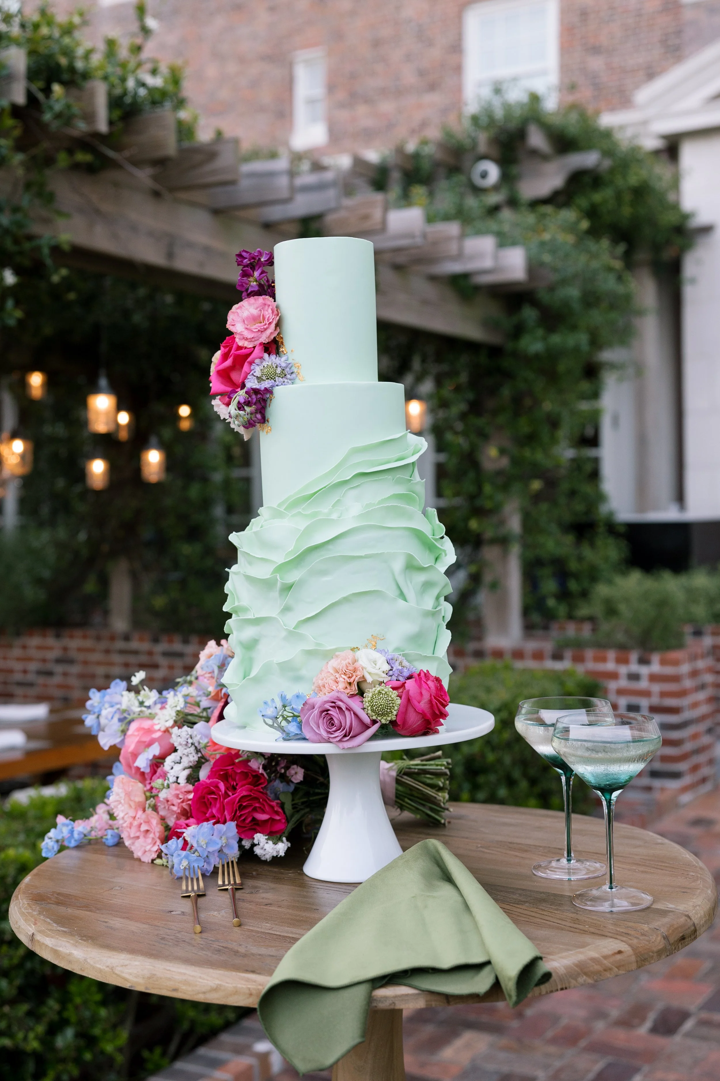 A whimsical green wedding cake at the Cavalier Resort in Virginia Beach at a styled wedding editorial shoot designed by By Love Events & Design