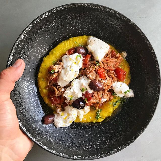 Hearty bowl of pork ragout on polenta with olives and burrata cheese #privatechef #holidaycooking #comfortfood #italianfood #italiancooking #instafood #instayum #instagood