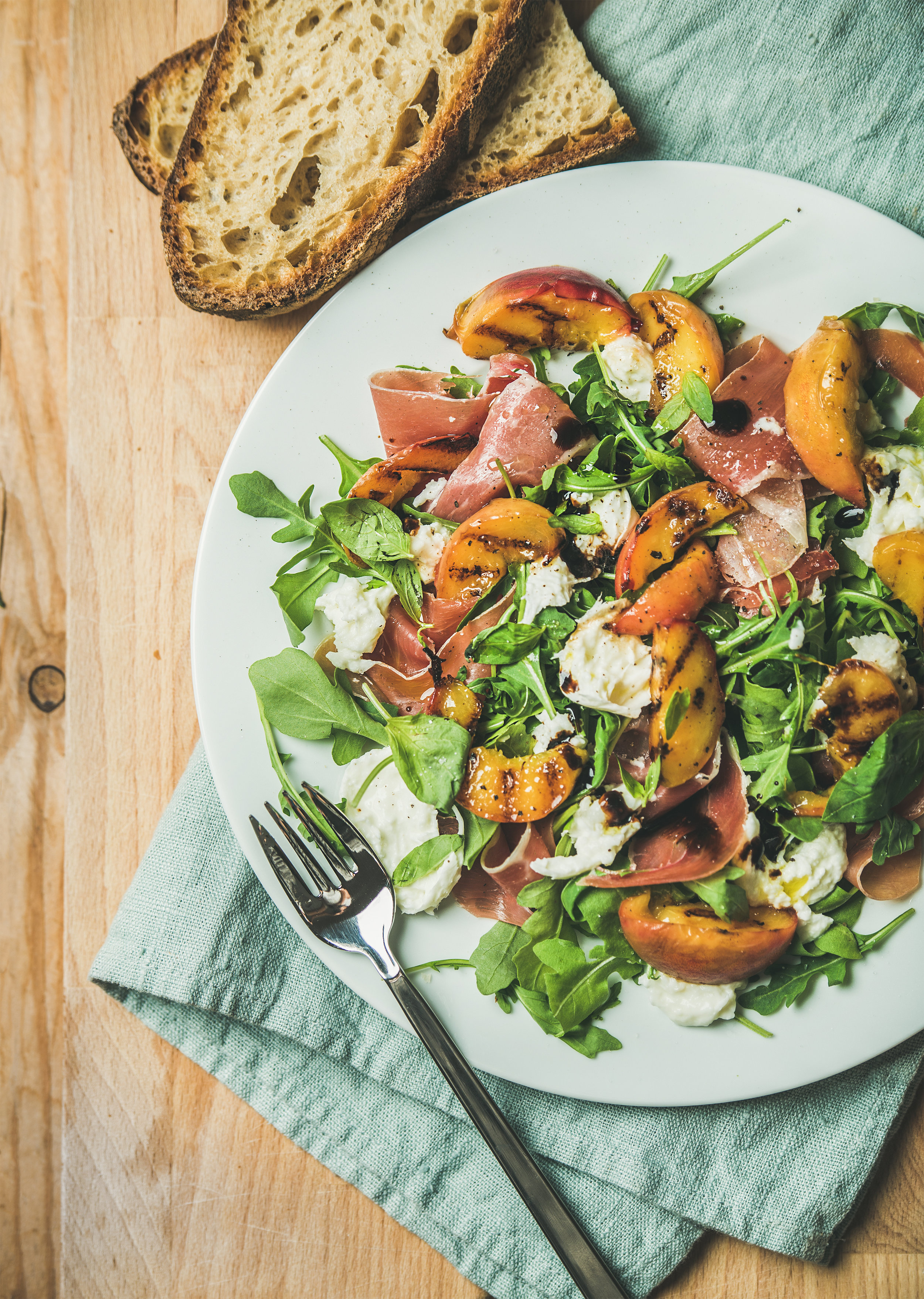 Arugula,-prosciutto,-mozzarella-and-grilled-peach-salad-in-white-plate-822165554_3201x4500.jpeg