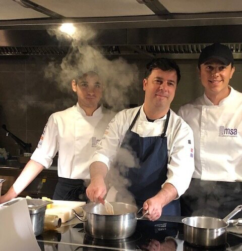 Chef Cem and his two student assistants testing recipes from the ‘The Cuisine of LIFE: Recipes and Stories of the New Food Entrepreneurs of Turkey’, a cookbook co-edited by Johanna that features recipes by refugee food entrepreneurs and essays about…