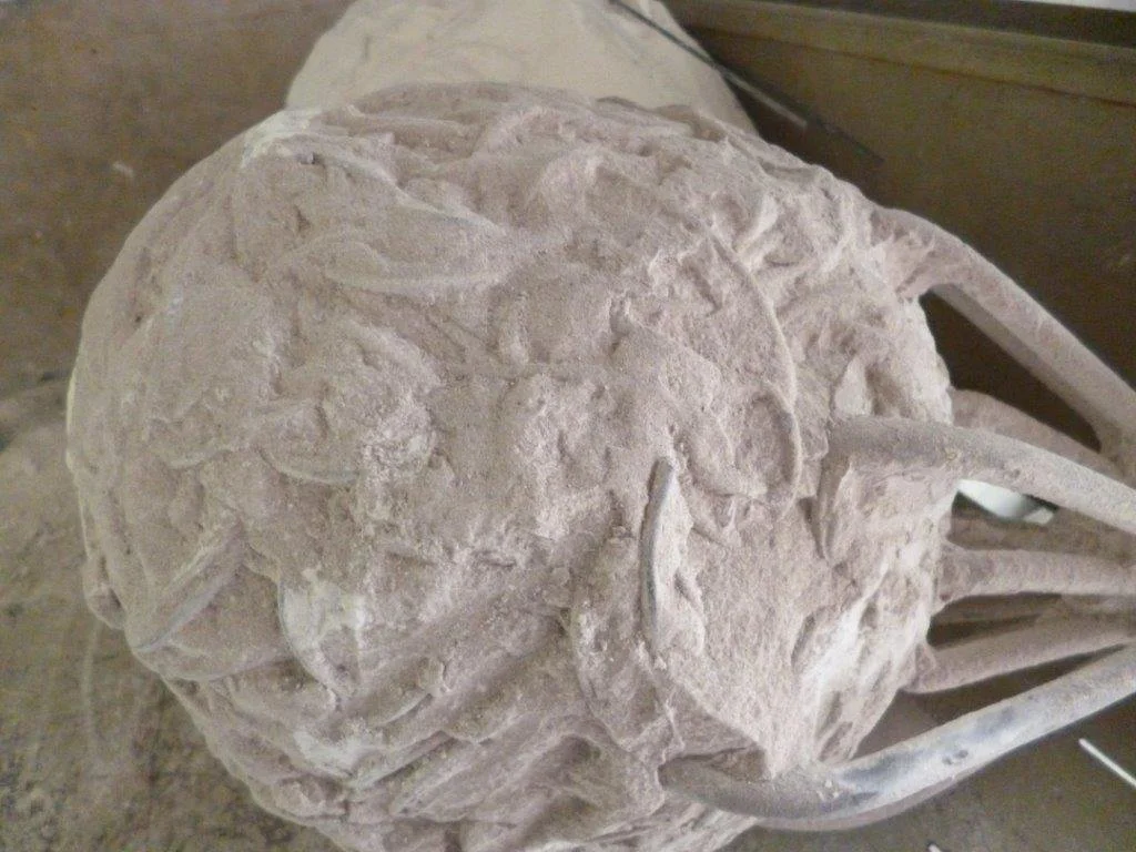 The wax sculpture is invested in plaster