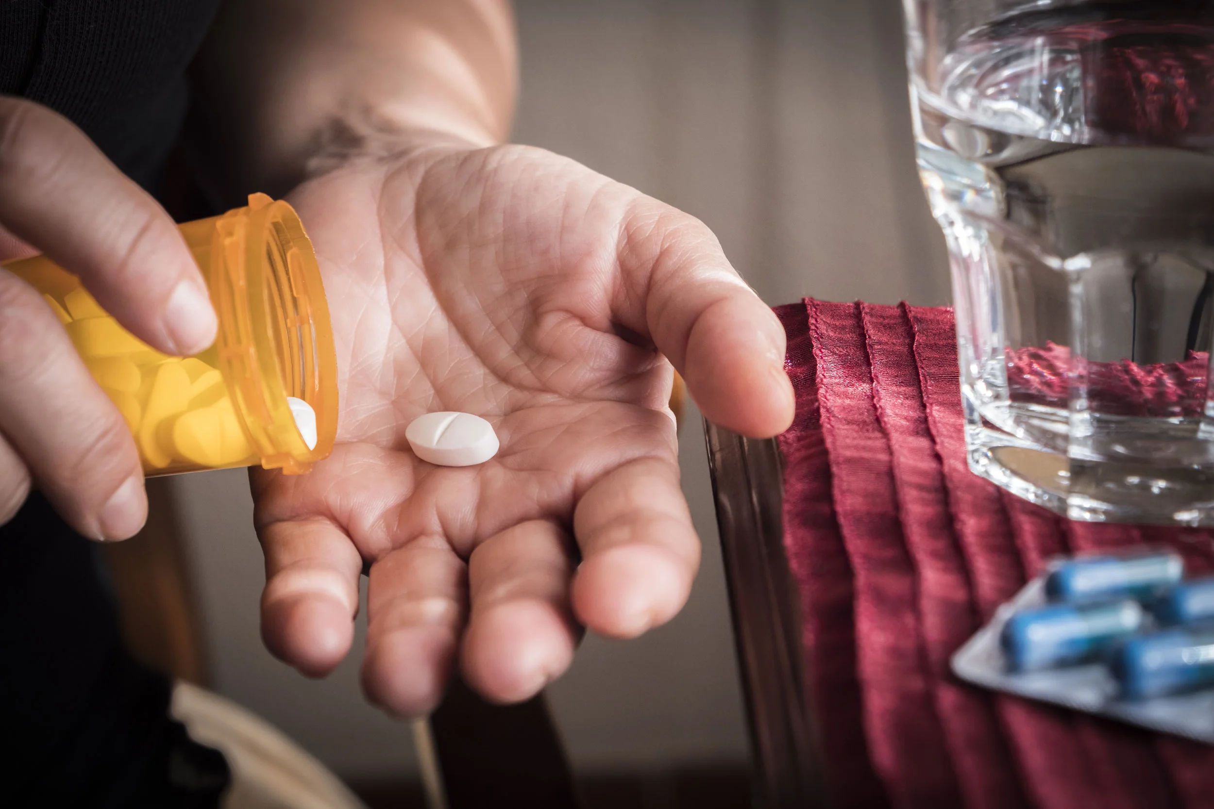 women-take-white-capsule-with-right-hand-from-a-PF3JUWH.jpg