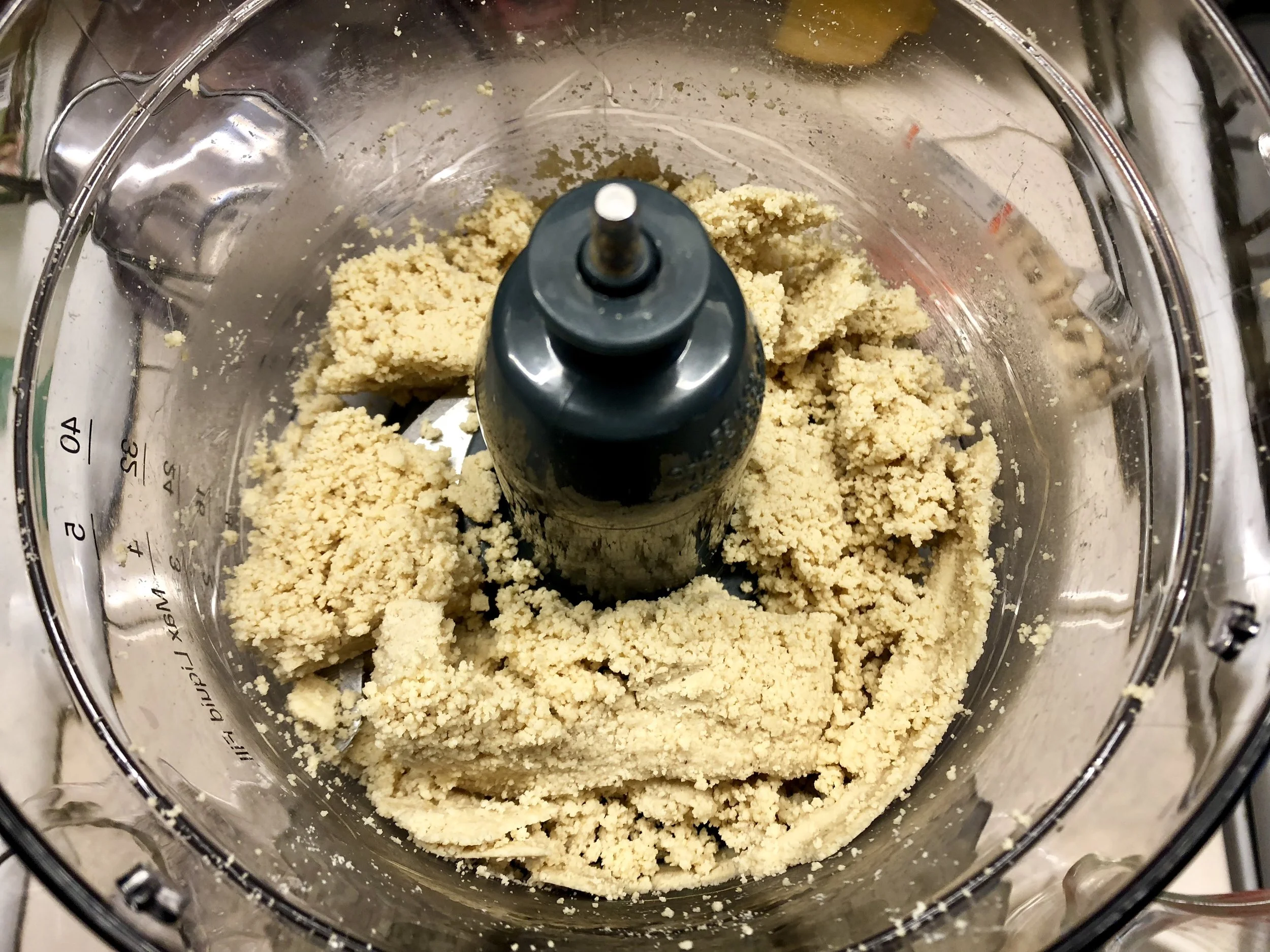 Scrap sides with spoons and continue to blend, chunks will begin to form.
