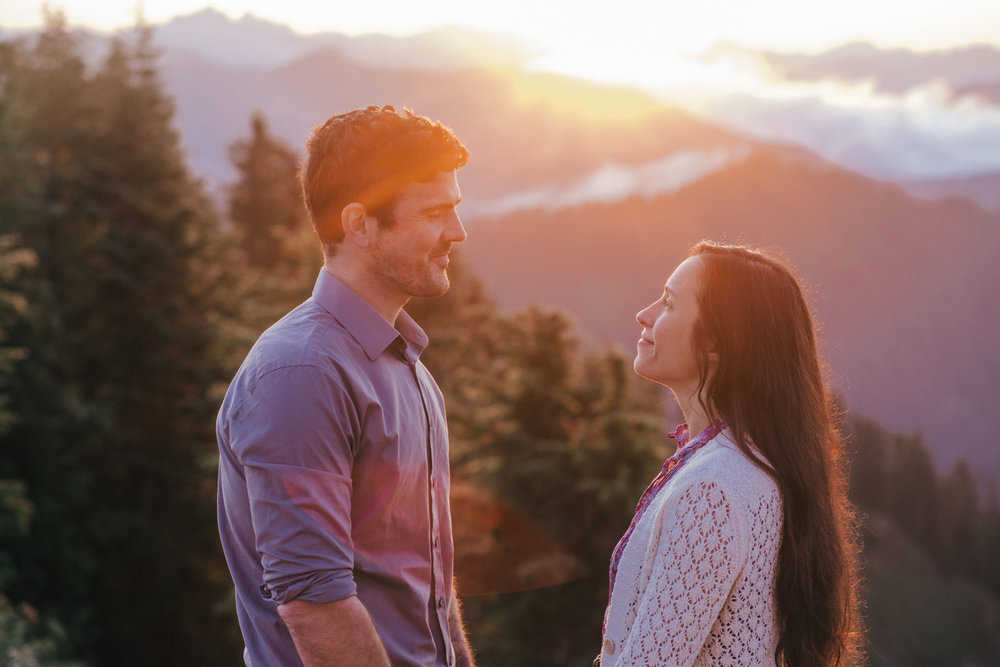 An adventurous couple in love during sunrise on Evergreen Mountain in Washington