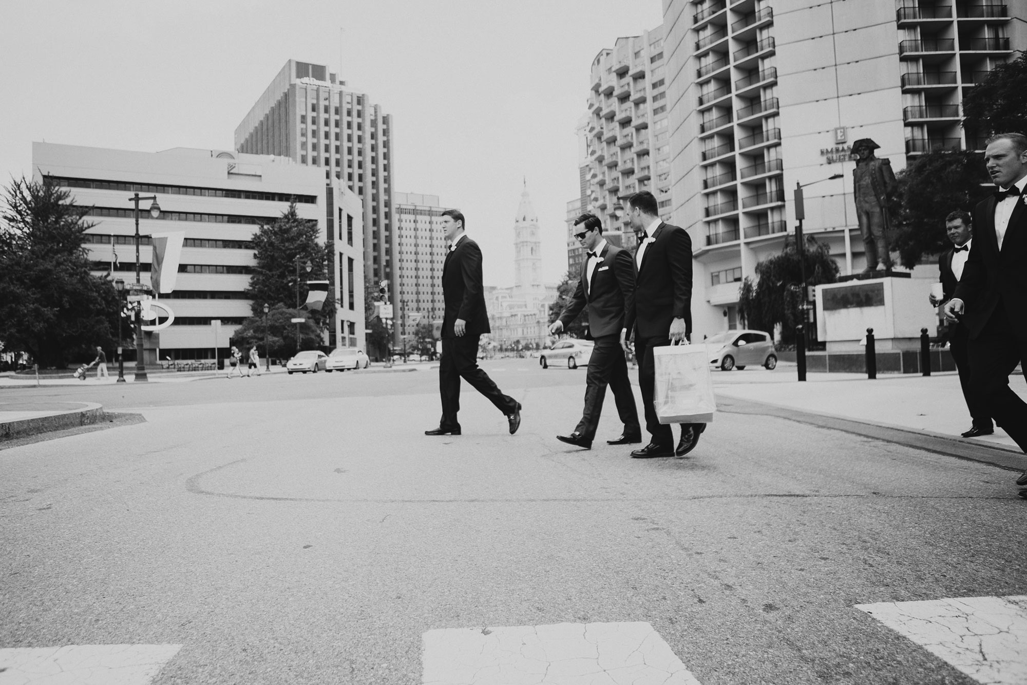 groomsmen walking across the Parkway in Philadelphia to get to the ceremony