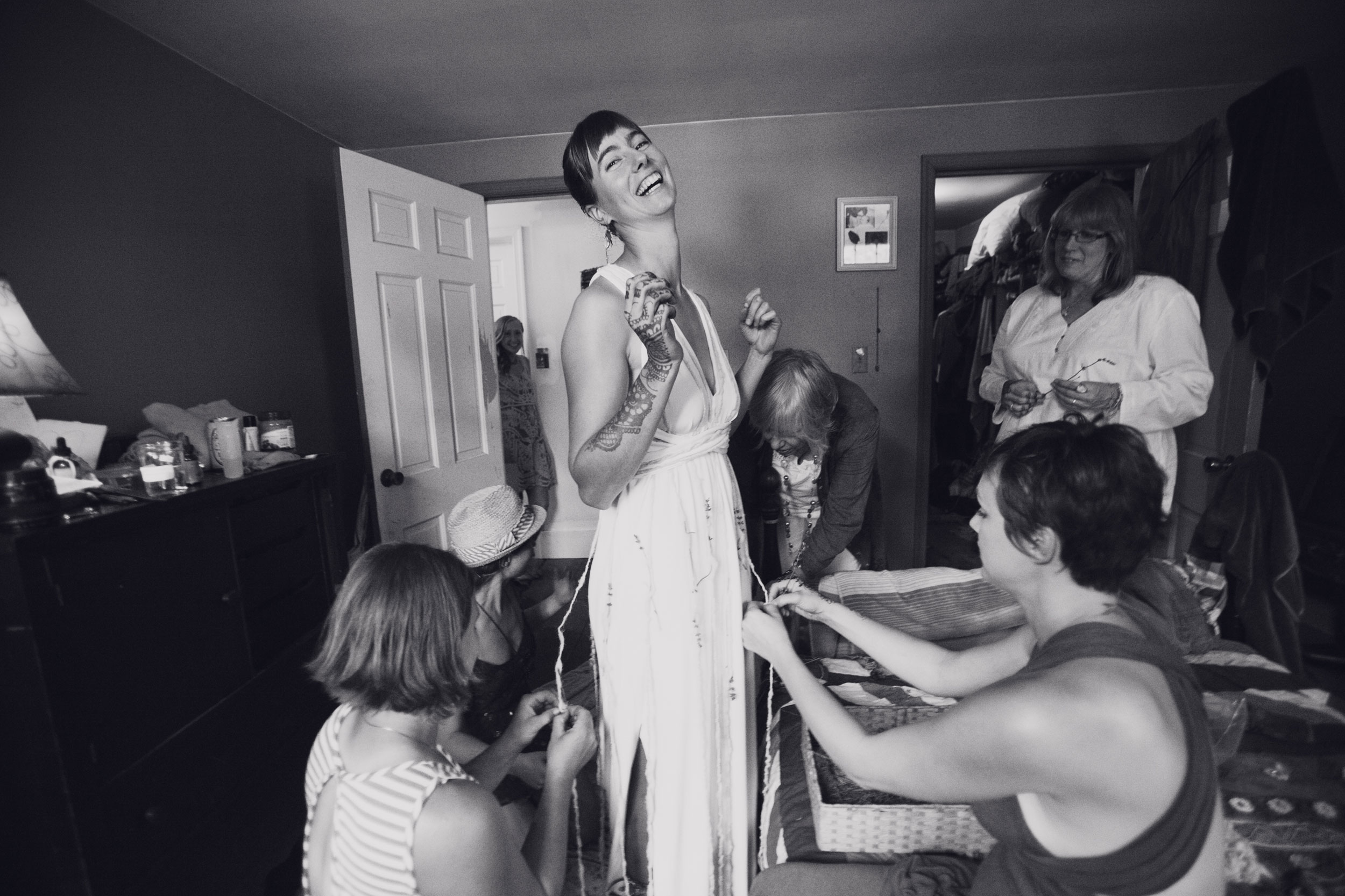 Bridesmaids helping a bride get ready on her wedding day